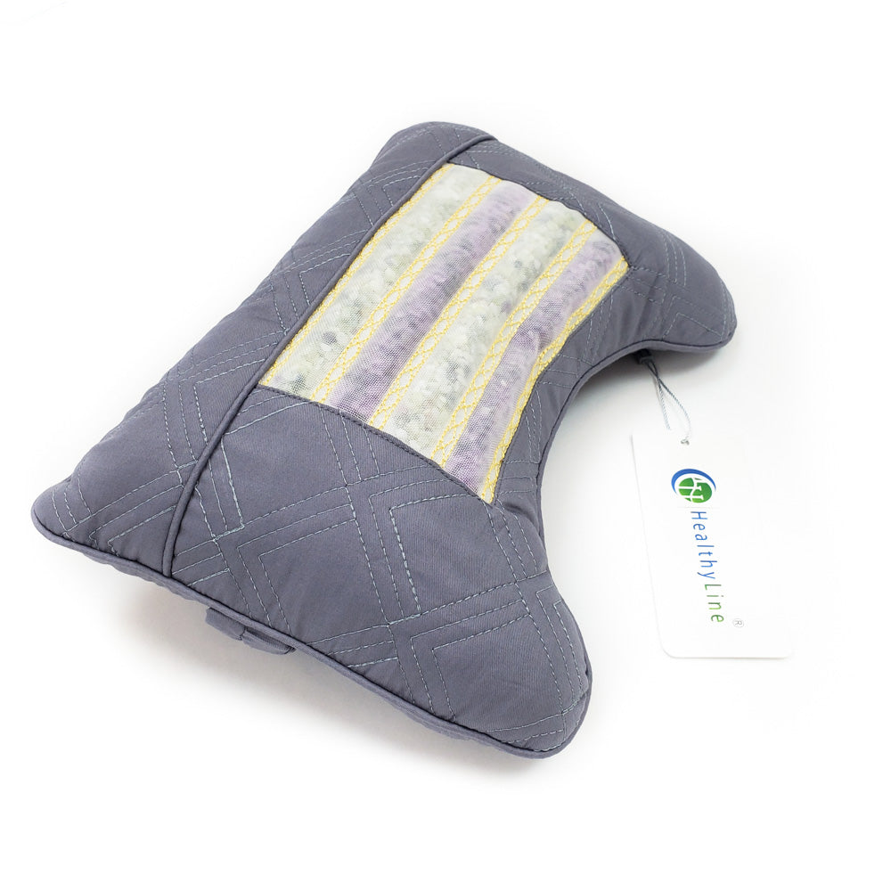 A dark gray, ergonomically shaped neck support pillow by HealthyLine features a striped, textured center and magnetic stimulation benefits. The Travel AJ Magnetic Pillow Firm InfraMat Pro® includes a "HealthyLine" tag on its side and is pictured against a white background.