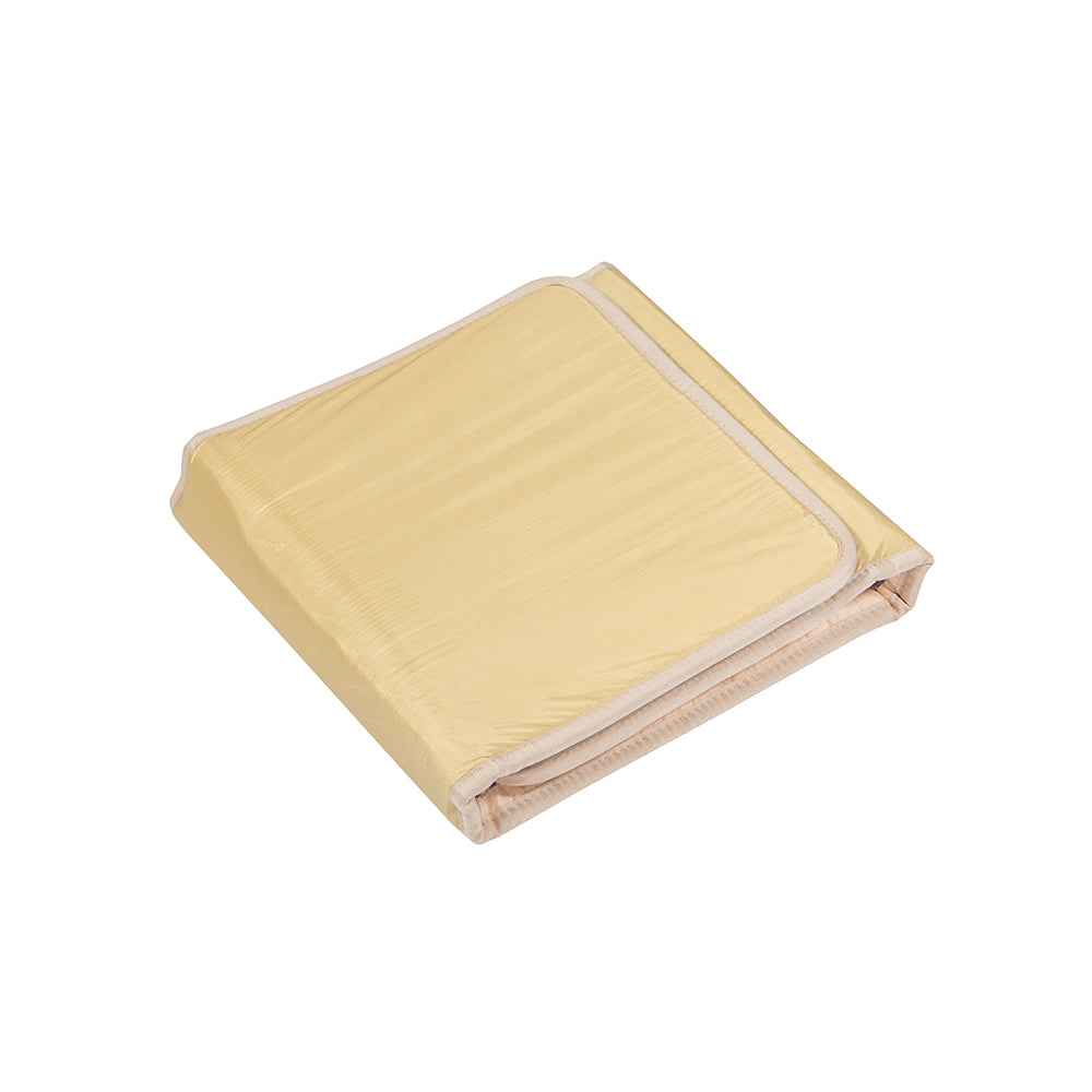 The TAJ-Mat™ Full 7224 Firm - Photon PEMF InfraMat Pro® by HealthyLine is a light yellow luxury heating mat with beige trim, shown neatly folded on a white background, blending style with wellness benefits.