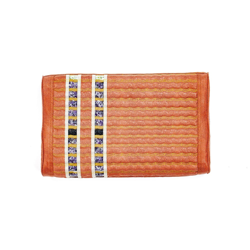 An orange woven TAO-Mat® Pillow Soft InfraMat Pro® by HealthyLine, featuring a textured pattern with a hint of amethyst, includes vertical bands adorned with small floral images near the left edge.