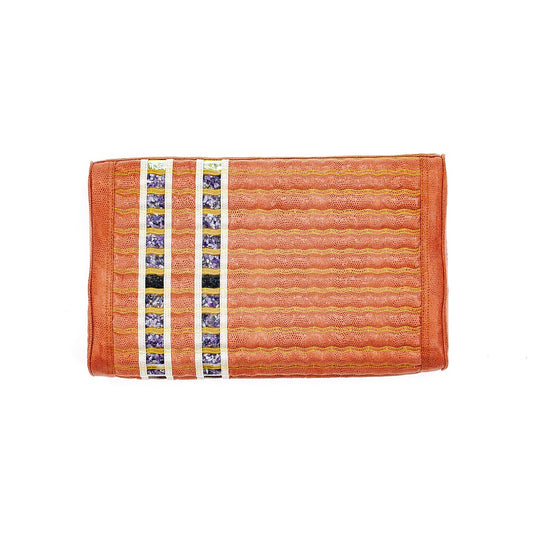 An orange woven TAO-Mat® Pillow Soft InfraMat Pro® by HealthyLine, featuring a textured pattern with a hint of amethyst, includes vertical bands adorned with small floral images near the left edge.