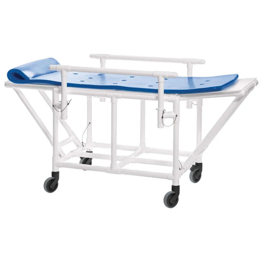 The Direct Supply Manual Shower Bed, featuring a fold-down deck and a 300lb weight capacity, comes in blue and white. It is equipped with locking casters for secure mobility and includes wheels for ease of movement. The surface is designed with drainage holes, while side rails and a slightly elevated headrest ensure patient comfort and safety.
