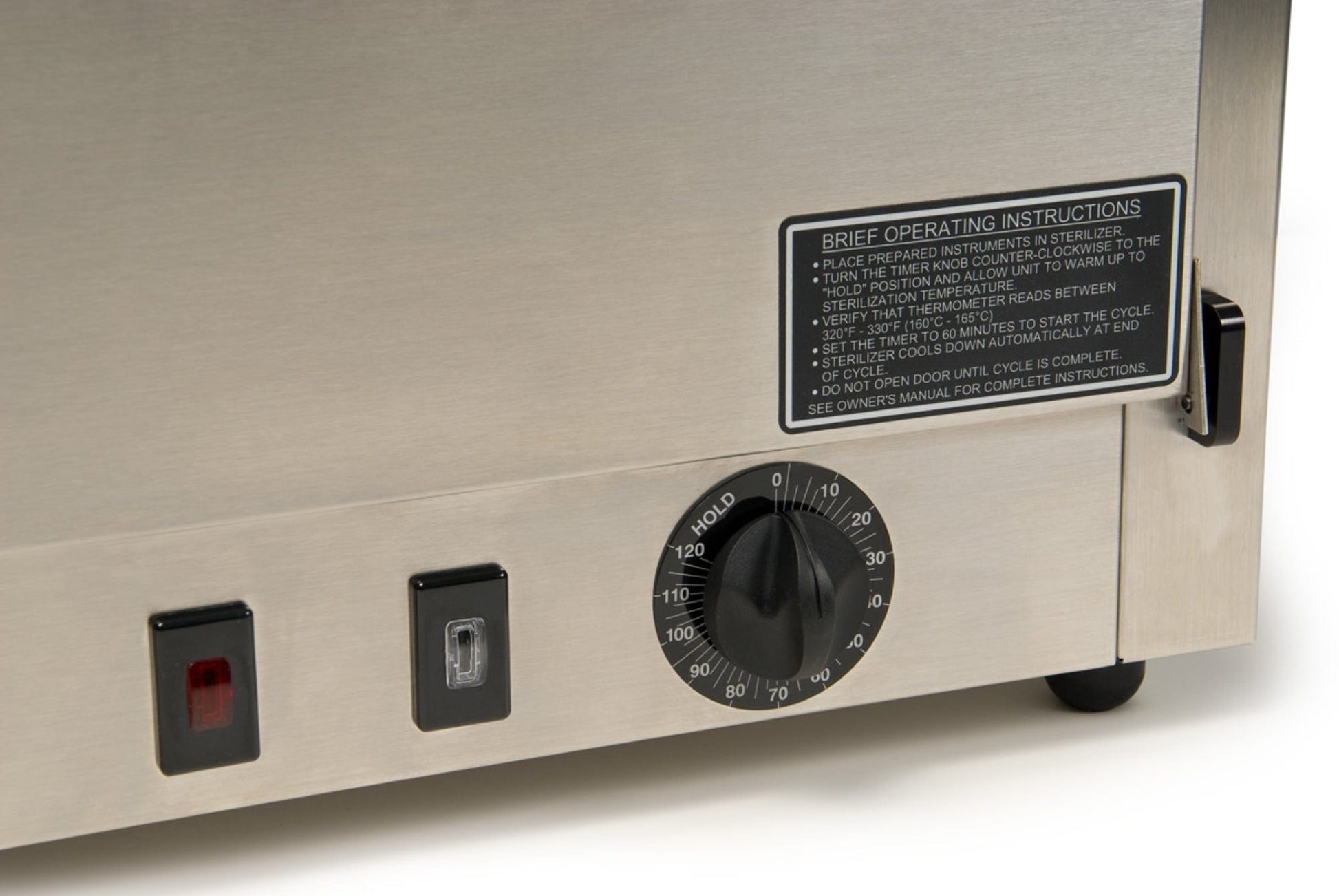 Close-up of a Graham Field Stainless Steel Dry Heat Sterilizer, featuring a dial with temperature settings ranging from 90 to 150. The device includes visible black and red switches, along with a label detailing operating instructions for sharp instruments. This maintenance-free appliance sits on a countertop.