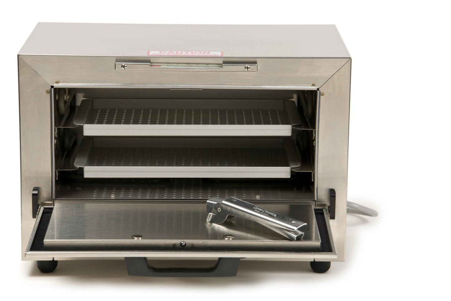 The Graham Field Stainless Steel Dry Heat Sterilizer, featuring two perforated racks inside, is perfect for sterilization purposes. With the front door open and a metal accessory placed on it, its sleek industrial design makes it suitable for both professional and home use while providing maintenance-free convenience to users.