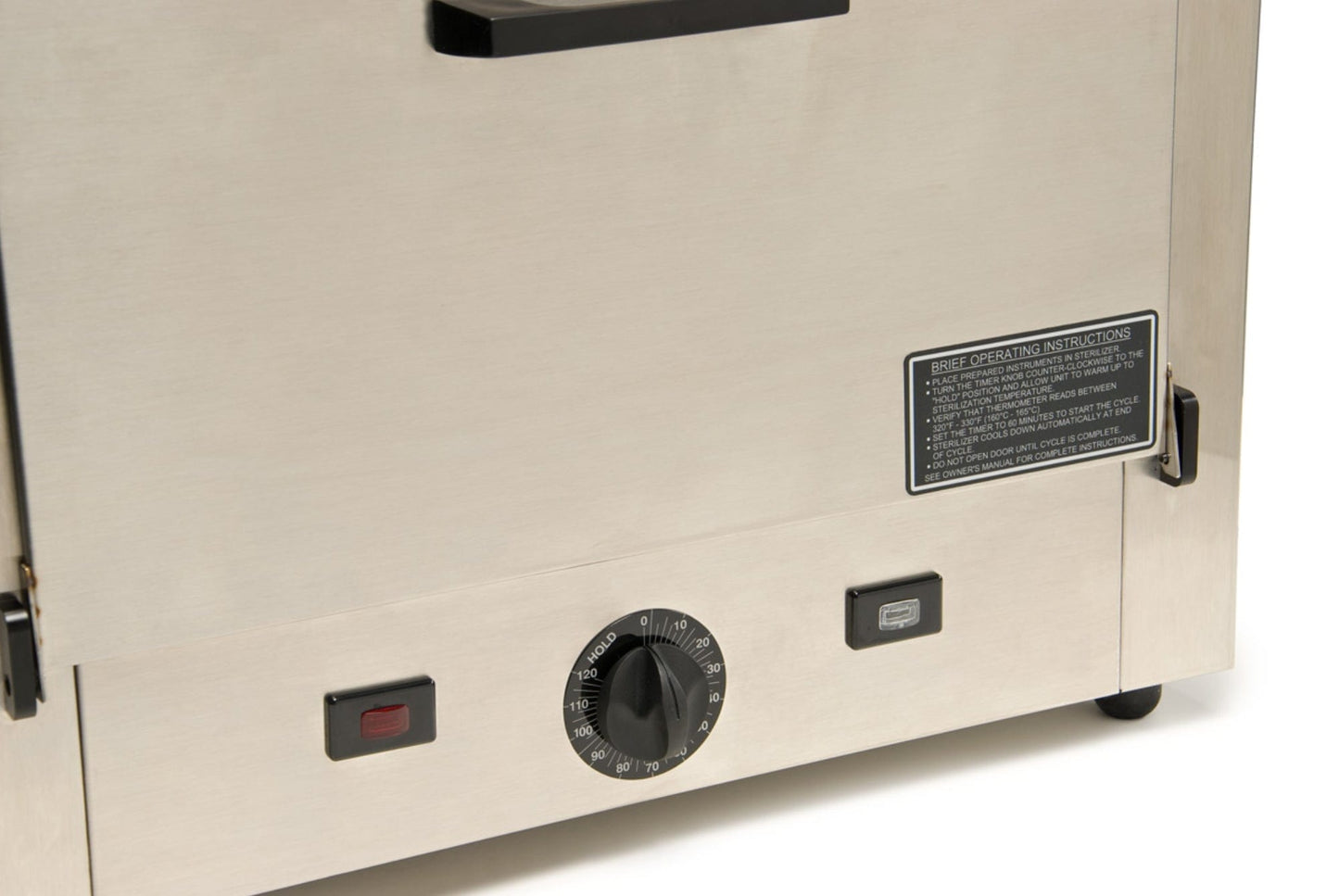 Here's a revised sentence based on the given product data:
A close-up view of the Graham Field Stainless Steel Dry Heat Sterilizer showcases its sleek stainless steel oven control panel. The design features a central round temperature dial flanked by two rectangular buttons, one in red and the other in gray. It’s perfect for maintenance-free operation and comes with an instruction label situated above the controls, making it ideal for dry heat sterilization tasks.