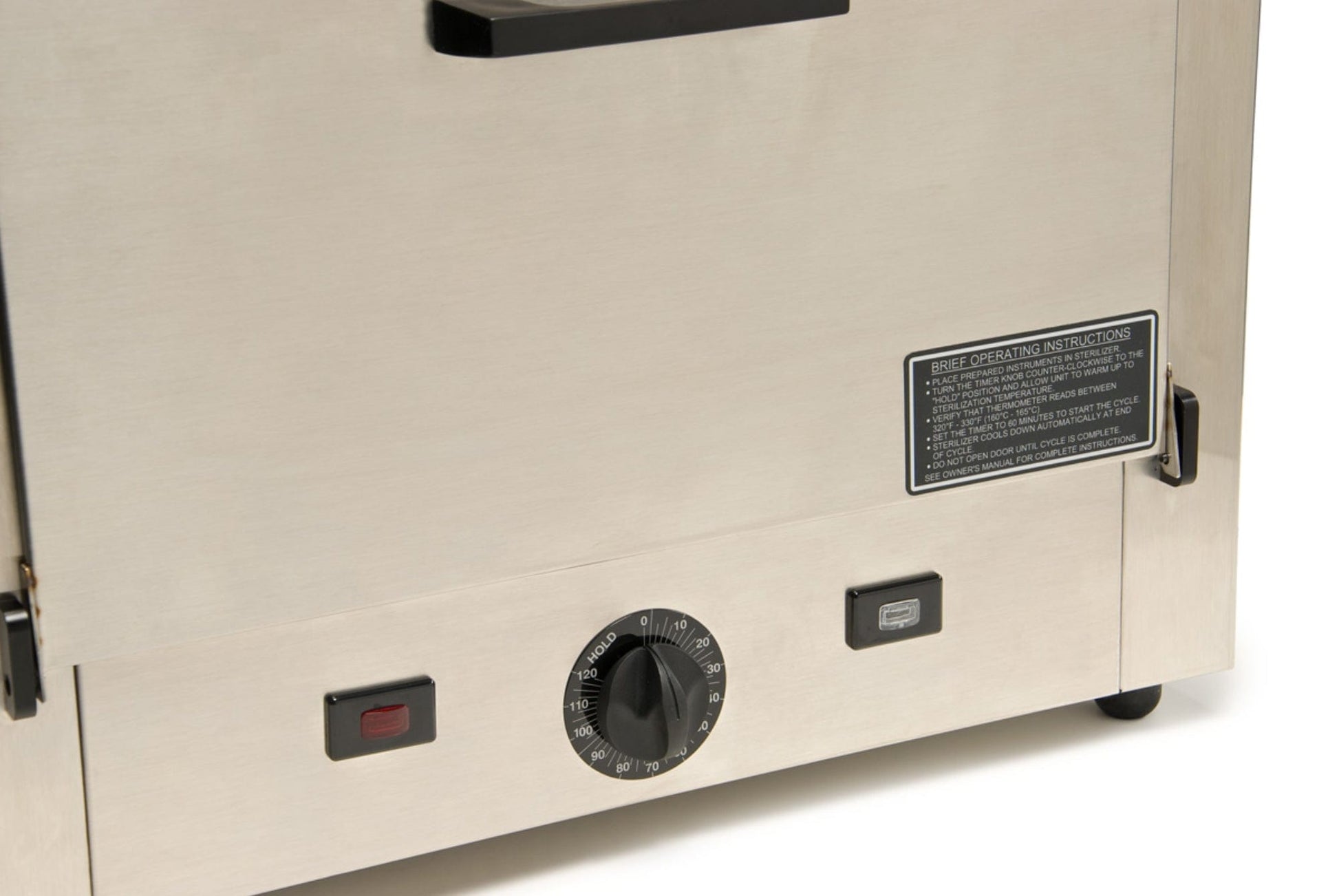 Here's a revised sentence based on the given product data:
A close-up view of the Graham Field Stainless Steel Dry Heat Sterilizer showcases its sleek stainless steel oven control panel. The design features a central round temperature dial flanked by two rectangular buttons, one in red and the other in gray. It’s perfect for maintenance-free operation and comes with an instruction label situated above the controls, making it ideal for dry heat sterilization tasks.