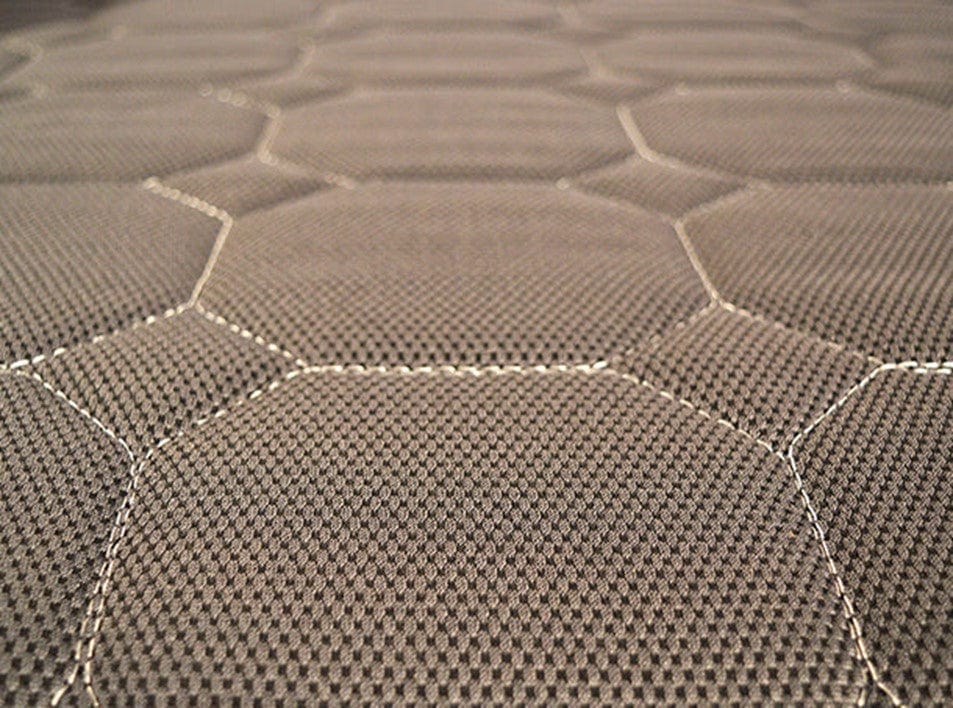 Close-up of the Upbed Standard by Journey Health & Lifestyle, showcasing textured fabric with large stitched hexagons in brown and gray. It creates an inviting honeycomb effect, combining style and comfort effortlessly.