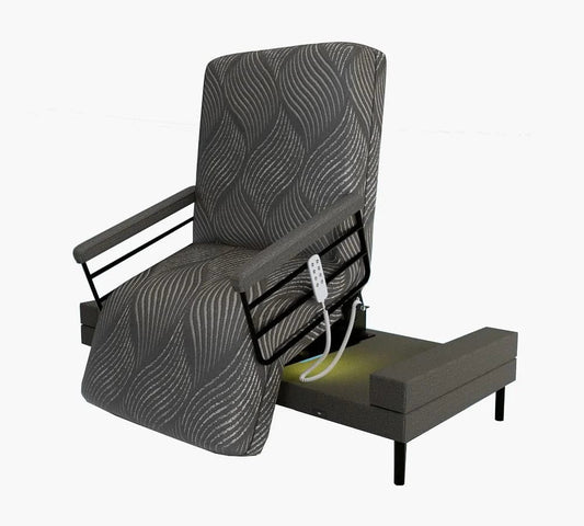 The Upbed Independence by Journey Health & Life Style is an electric recliner chair with patterned fabric and a memory foam mattress comfort. The chair is partially elevated, showcasing the base mechanism. A corded remote control attached to the right armrest allows for adjusting the chair's position.