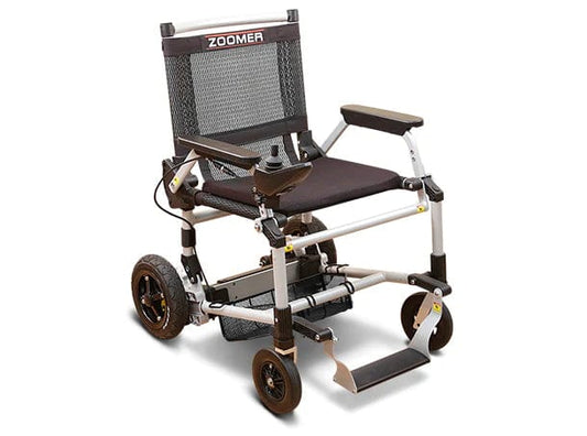 The Zoomer (w/ Joystick) by Journey Health & Life Style offers easy one-handed joystick steering, compact storage with a lightweight foldable design, and features a black mesh backrest, padded seat, footrest, four wheels, armrests, and removable battery for transport.