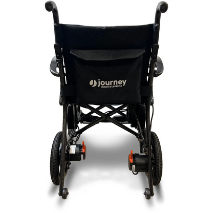 Rear view of the Air Elite Power Wheelchair by Journey Health & Life Style, shown in black with the logo on the backrest pocket. Designed for easy maneuverability, it features two large rear wheels and two smaller front wheels against a white background.