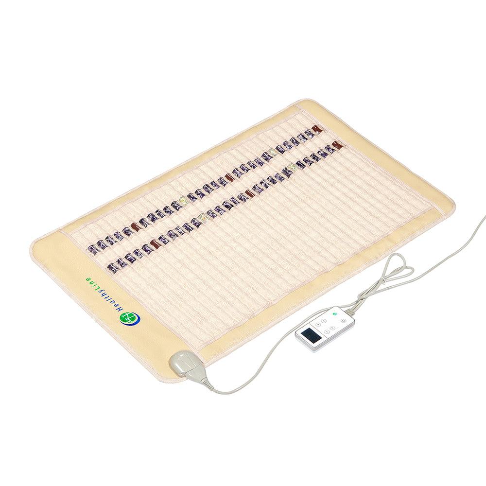 The SOFT Mat Medium 4024 InfraMat Pro® by HealthyLine is a rectangular heated gemstone mat featuring a beige trim and a central strip of mineral stones. It comes with an attached white remote control for adjusting the temperature settings. This mat is designed for therapeutic purposes, providing an enhanced experience with its innovative features.