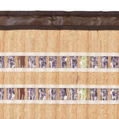 Close-up of a HealthLine SOFT-Mat™ Full 7224 InfraMat Pro®, featuring a textured fabric mat adorned with two horizontal rows of semi-precious stones, including amethyst and green stones. These gemstones are set against a beige woven base with intricate patterns, framed by a brown border for full body therapy.