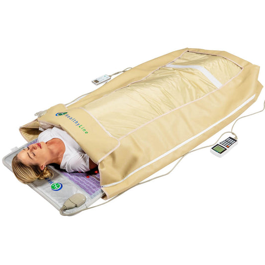 A person relaxes in a beige infrared sauna blanket from the HealthyLine 360 Wrap Set™ Platinum & SOFT Full Pro PLUS 7428, head exposed to enjoy soothing effects. The remote ensures a full-body experience enhanced by Photon Advanced PEMF InfraMat Pro®'s gemstone technology.