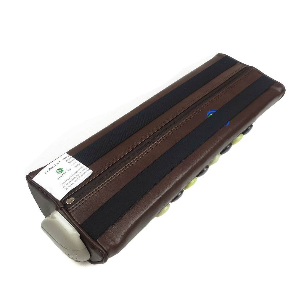 The HealthyLine Pebble JT Bolster Firm InfraMat Pro® is a brown, rectangular leather bag accented with jade and tourmaline gemstones. It features a zipper on top and has rubber feet on one side. A label is attached, and there's a line of black and green spherical buttons along the side, indicating its design for far-infrared ray benefits.