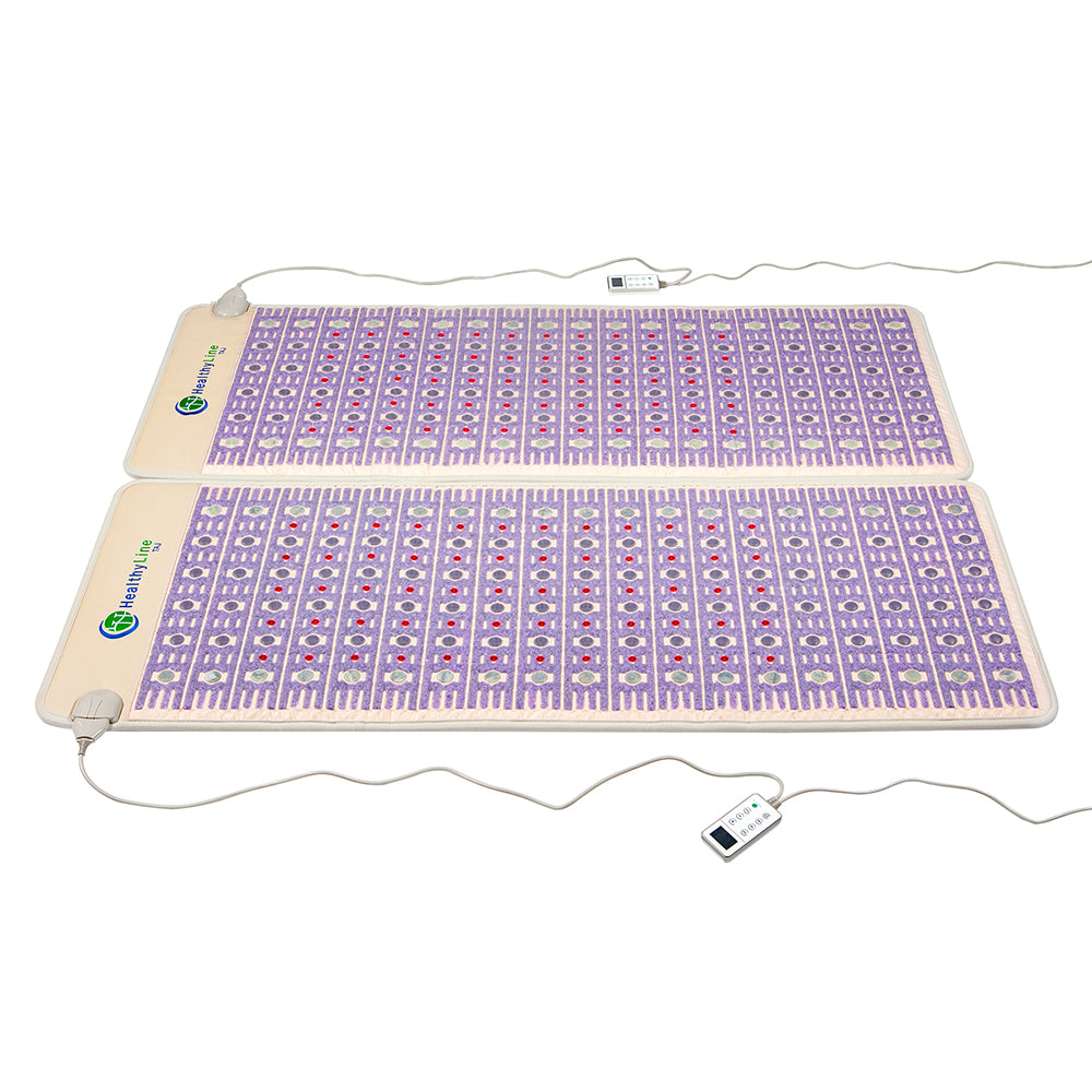 Two TAJ-Mat™ Queen 8060 Firm - Photon PEMF Split Inframat Pro® pads by HealthyLine, featuring a purple geometric pattern, are positioned flat on a white surface. They're connected via cords to control units for far infrared heat and PEMF therapy.