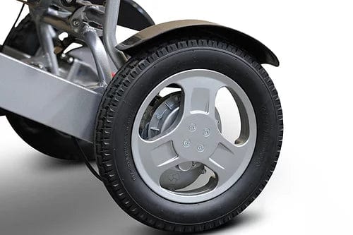 Close-up of a single tire on a modern, sleek vehicle with a metal rim and visible brake caliper. The tire's tread and wheel design resemble the practicality of the E-Wheels EW-M45 Portable Power Wheelchair, offering efficient mobility akin to personal transport solutions ideal for urban settings.
