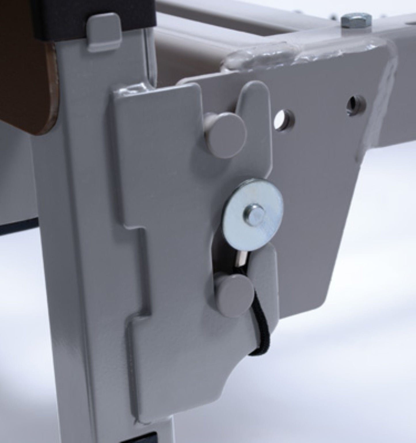 Close-up of a metallic latch mechanism on the adjustable frame of the Graham Field Patriot Homecare Beds, Semi-Electric model, featuring a circular component with a black cord and two round pegs, set against a white background. This product proudly showcases its MADE IN THE USA quality.