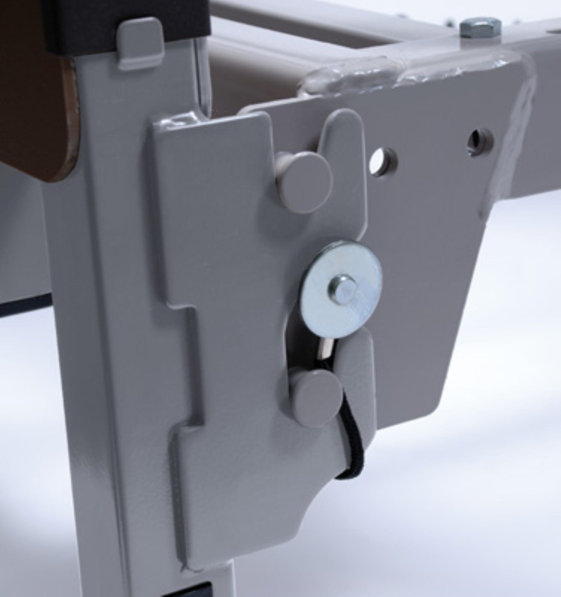 Close-up of a metallic latch mechanism on the adjustable frame of the Graham Field Patriot Homecare Beds, Semi-Electric model, featuring a circular component with a black cord and two round pegs, set against a white background. This product proudly showcases its MADE IN THE USA quality.