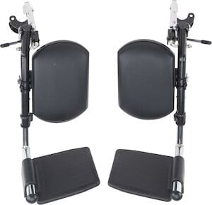 The Swing-Away ELEV Leg Rest in chrome, by Drive Medical, features two upright detachable units with black footplates and cushioned calf pads. The adjustable metal support bars display the attachment mechanisms for these wheelchair legrests.