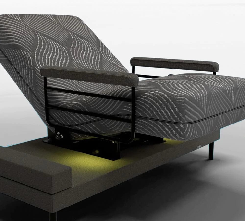 A contemporary lift bed by Journey Health & Lifestyle, the Upbed Independence showcases a chic black and gray patterned memory foam mattress. It features elegant black metal side rails and a subtle glowing light beneath, all set against a minimalist white backdrop.