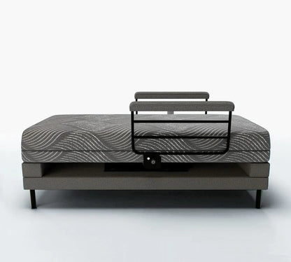 A contemporary lift bed by Journey Health & Lifestyle, the Upbed Independence includes a memory foam mattress with a patterned design and an elevated headrest support. It showcases minimalist elements and a durable metal frame, set against a plain, light-colored wall.