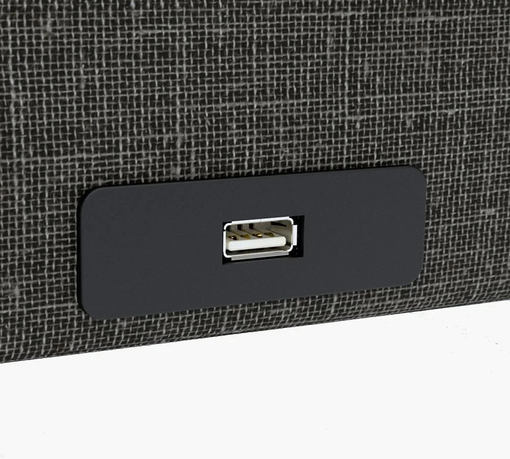 A sleek black USB port is set into a textured dark gray surface, providing seamless connectivity right next to your Journey Health & Lifestyle's Upbed Independence.