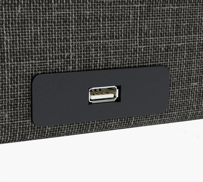 A sleek black USB port is set into a textured dark gray surface, providing seamless connectivity right next to your Journey Health & Lifestyle's Upbed Independence.