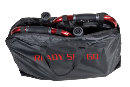 A Drive Medical Travel Walker with Folding Legs, its wheels and collapsible legs partly visible, carried in a black bag featuring "READY SET GO" in red.