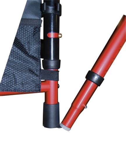 Close-up of a Drive Medical Travel Walker's red metal frame with black plastic caps and hinges, likely part of its collapsible structure. A section is covered with black fabric and mesh, characteristic of the brand's design.