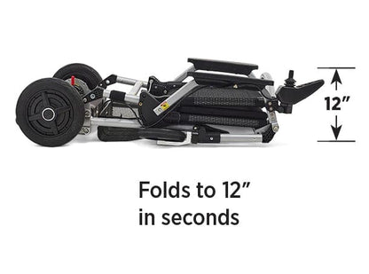 The Journey Health & Lifestyle Zoomer mobility scooter, in compact black and silver, folds to just 12" high in seconds. It features a removable battery, visible wheels, folding joints for portability, and one-handed joystick steering for easy use.