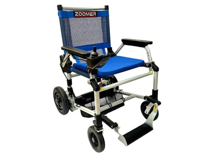 The Zoomer by Journey Health & Lifestyle is a lightweight, foldable power wheelchair in blue featuring a mesh backrest and seat. It includes a right-armrest joystick for one-handed steering, a removable battery, four wheels, and a sturdy frame for easy maneuverability.